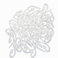 White plastic hooks on a white background