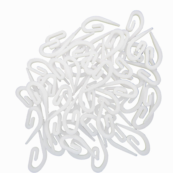 White plastic hooks on a white background