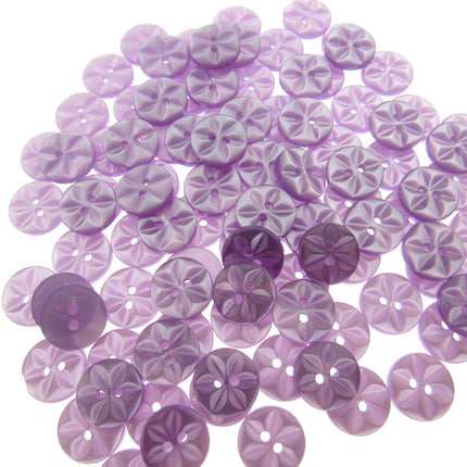 An array of colorful round star-shaped baby buttons in various colors including green, orange, pink, purple, yellow, and clear.