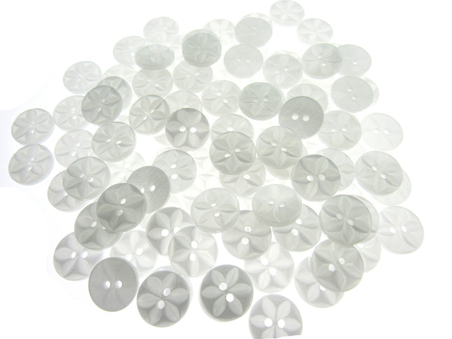 An array of colorful round star-shaped baby buttons in various colors including green, orange, pink, purple, yellow, and clear.
