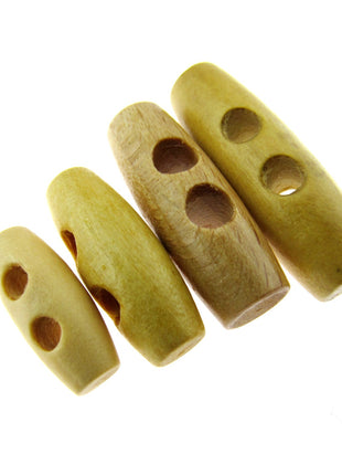 A set of beige wooden toggles with two drilled holes each, arranged in a row on a white background.
