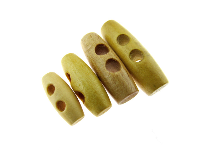 A set of beige wooden toggles with two drilled holes each, arranged in a row on a white background.