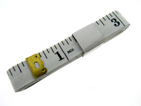 White measuring tape with black markings and gold measurement indicator on a white background