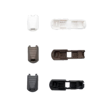 Set of plastic cord lock ends on a white background