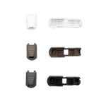 Set of plastic cord lock ends on a white background