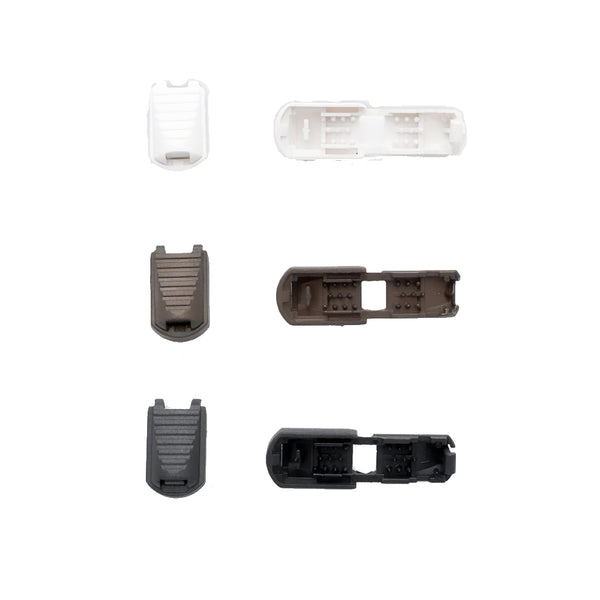 Set of plastic cord lock ends on a white background