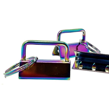 Iridescent rainbow metallic belt buckle keychains with key rings, shown on a plain white background.