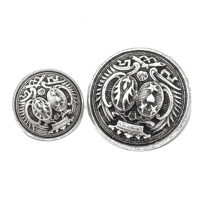 Two round silver-toned decorative buttons with embossed heraldic designs, shown on a plain white background.