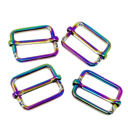 Four metallic double-loop buckles with an iridescent rainbow finish, arranged on a plain white background.