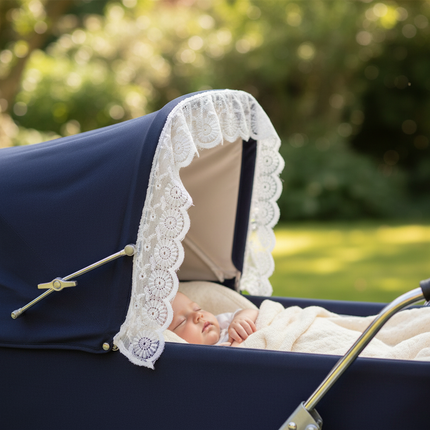 Navy pram with white broderie anglaise trim — close-up