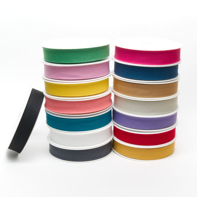 A collection of colorful cotton webbing with patterned basket weave, stacked together.