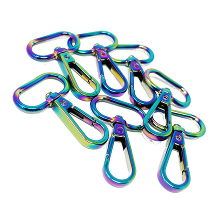 A pile of metallic clip-on keychains with an iridescent rainbow finish, displayed on a clean white background.