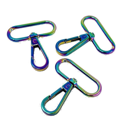 Three metallic clip-on keychains with an iridescent rainbow finish, displayed on a clean white background.
