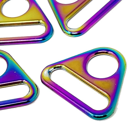 Four triangular metal ring clips with an iridescent rainbow finish, arranged on a plain white background.