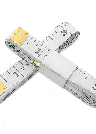 Two crossed tape measures with gold ends on a white background