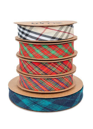 A stack of various tartan patterned bias bindings in different colors, with the brand name 'Trimz' visible on the top binding.