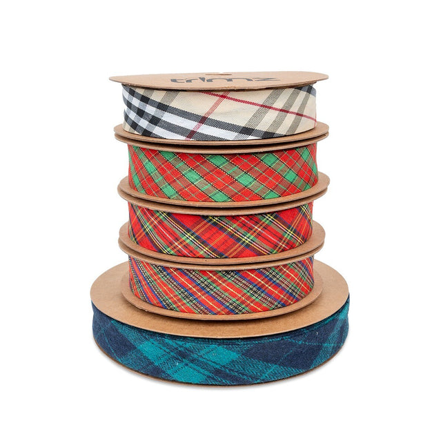 A stack of various tartan patterned bias bindings in different colors, with the brand name 'Trimz' visible on the top binding.