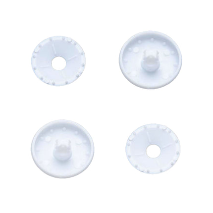 Four white plastic self cover buttons on a white background