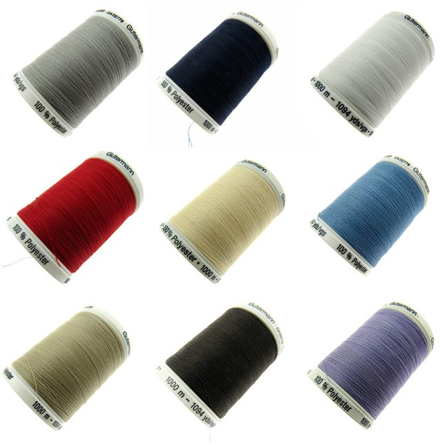 A collection of Gutermann Sew All Polyester 1000 meter Thread spools in various colours including beige, navy, red, cream, blue, black, and purple.