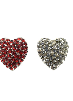Two heart-shaped diamante buttons with shank, one with red crystals and one with clear crystals, against a white background.