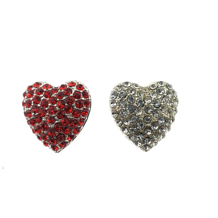 Two heart-shaped diamante buttons with shank, one with red crystals and one with clear crystals, against a white background.