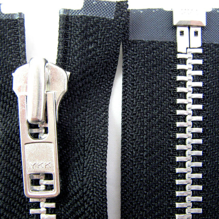Close-up of a heavy-duty metal open-end zip by YKK, showing the teeth and slider against a black background. 