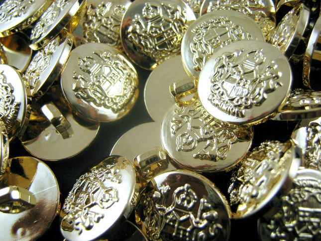 A collection of gold plastic crested blazer buttons with shank attachments.