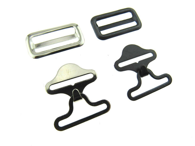 A set of bow tie clips in black and silver colors, including different styles of clips typically used for securing bow ties on clothing.