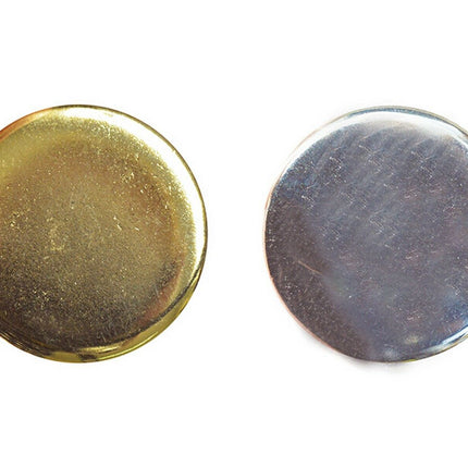 Two round metal blazer buttons, one polished gold and one polished silver, with a shank attachment.