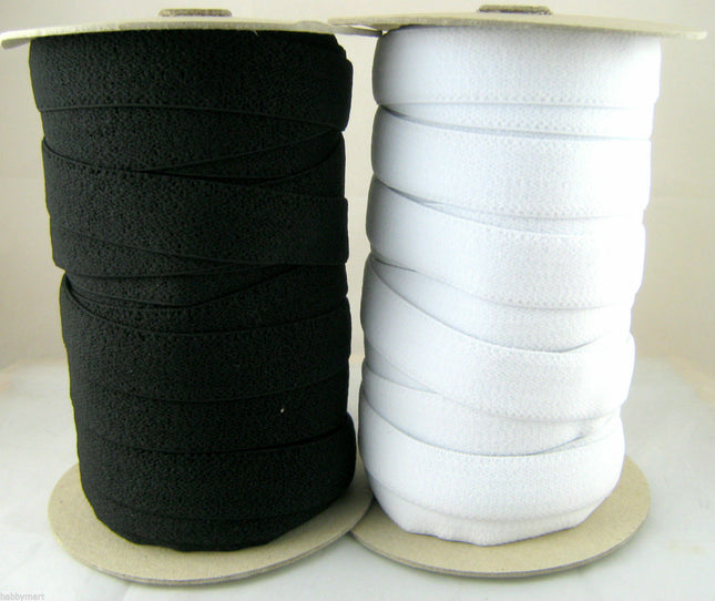 Rolls of plush back elastic in black and white, showing the soft velvety side intended for skin contact.