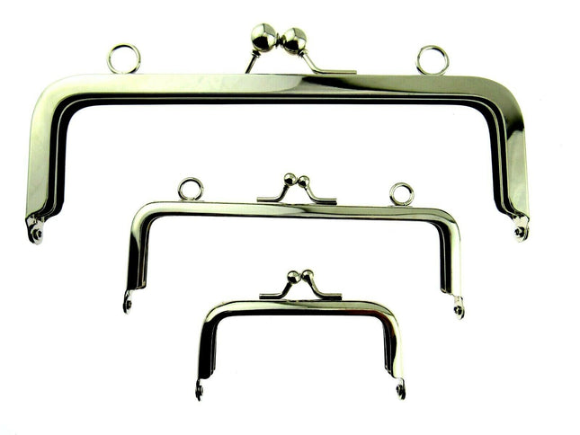 A collection of silver metal purse frames on a white background