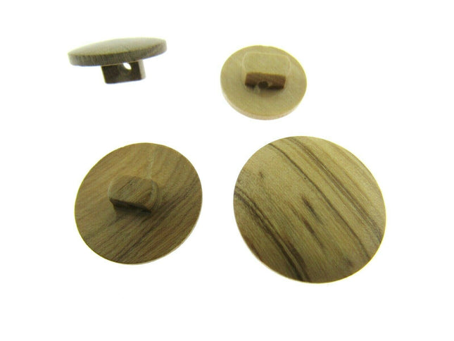 A set of round wooden buttons made from olive trees, displayed in different sizes, showing the natural grain of the wood.