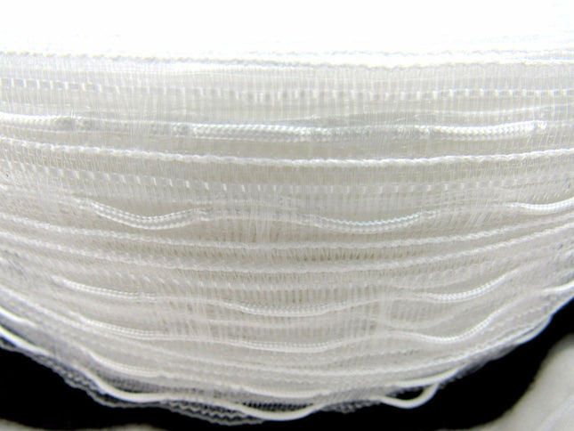 A roll of white, translucent Austrian blind curtain tape with cross loops for draw cords, displayed on a black background.