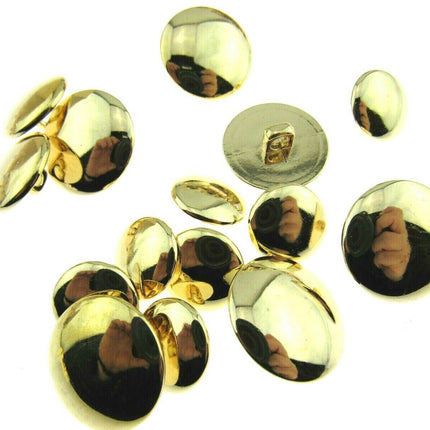 A collection of round shiny gold plastic blazer buttons with shank and bevelled top.