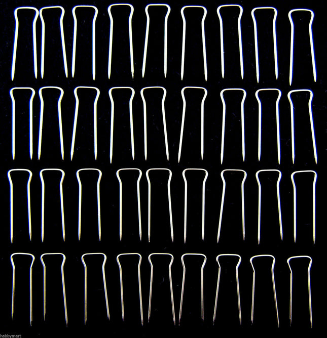 An array of double pointed pins used for upholstery, displayed in rows on a dark background.