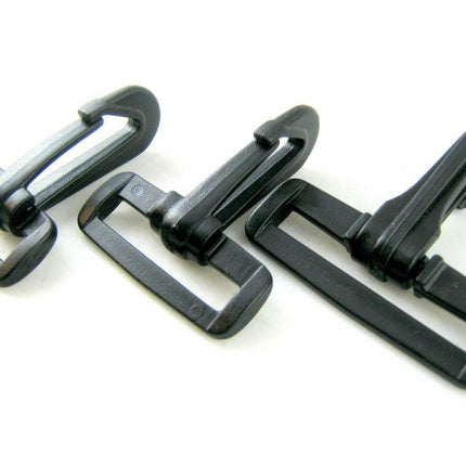 Three black plastic snap hooks of different sizes arranged in a row on a white background.