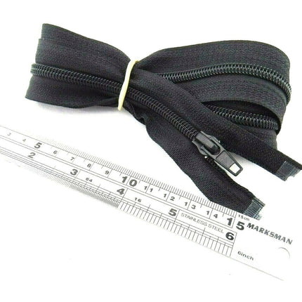 An extra long sleeping bag zip placed next to a ruler, showing its length.