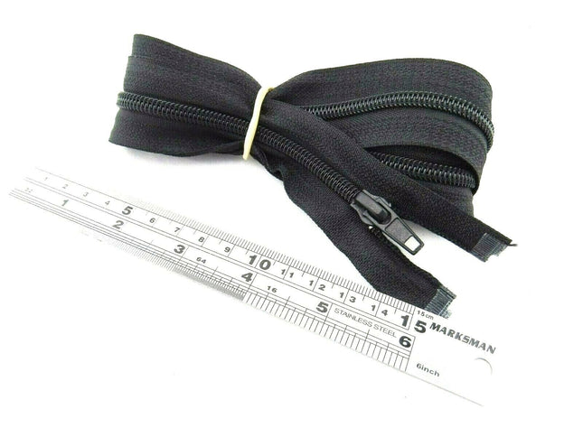 An extra long sleeping bag zip placed next to a ruler, showing its length.