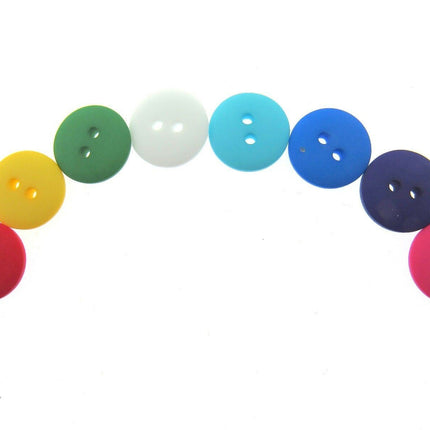 An assortment of round, double domed buttons in various colors displayed in a row.