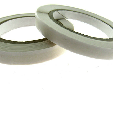 Two rolls of double-sided sticky tape with a white backing and clear adhesive, displayed on a plain background.