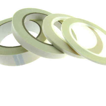 Reels of double-sided sticky tape laid out on a surface.