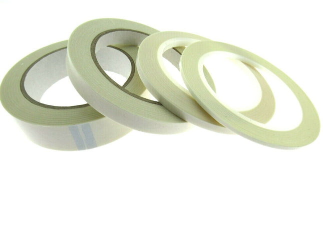 Reels of double-sided sticky tape laid out on a surface.