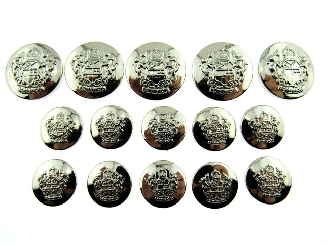 A collection of round silver plastic crested blazer buttons, varying in size and with a reflective silver finish.