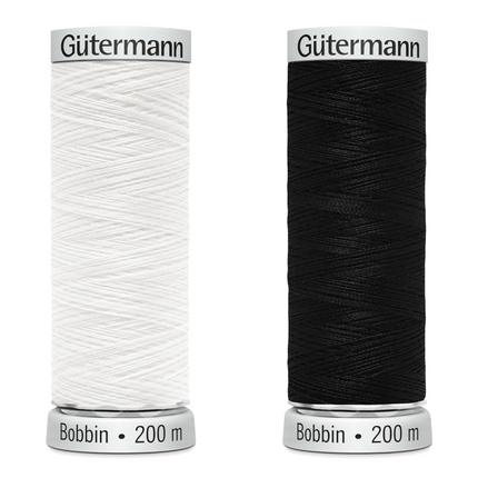 Two reels of Gutterman Sulky bobbin embroidery thread in black and white, each with 200 meters of thread.