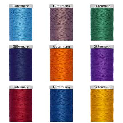 A collection of Gutermann Extra Strong Upholstery Thread spools in various colors.