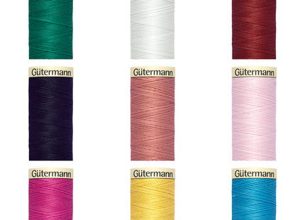 A collection of Gutermann Sew All sewing thread in various colors, displayed in individual spools.