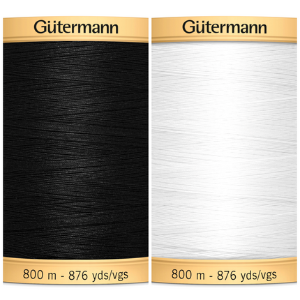 Two reels of Gutermann cotton thread, one in black and one in white, each with text indicating the brand and length of 800 meters.