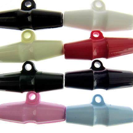 An array of barrel-shaped duffle coat toggle buttons in various solid colors including black, white, red, yellow, pink, and blue.