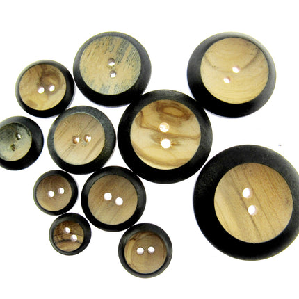 A selection of burnt rim wooden buttons in different sizes on a white background