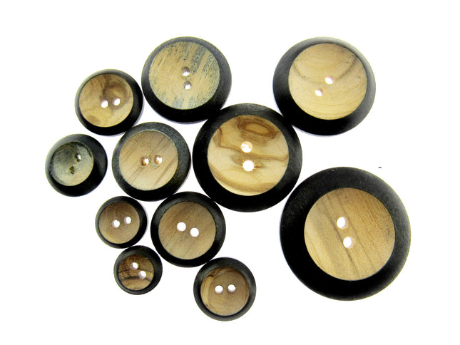 A selection of burnt rim wooden buttons in different sizes on a white background